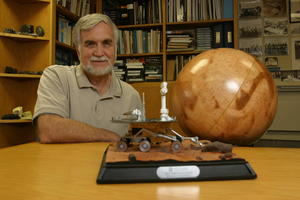 Ronald Greeley with a Mars Exploration Rover model and globe